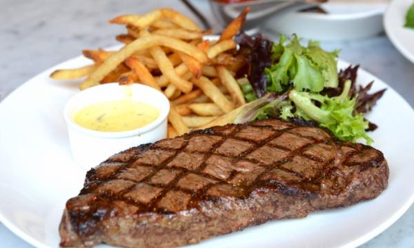 Grilled Rib Eye Steak Served With Fries, Salad And Sauce
